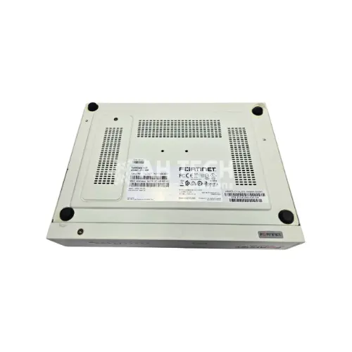 Bottom view of a white Fortinet network appliance, showing ventilation grills and product labels.